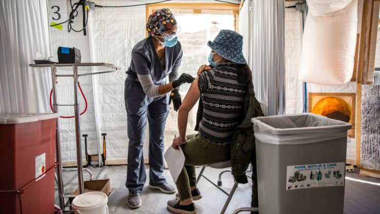 Anjali Sundararaman, a student nurse at San Francisco State University, administers a dose of Moderna COVID-19 vaccine to Cuixia Xu during a vaccination clinic at the Southeast Health Center in the Bayview-Hunters Point neighborhood in San Francisco, Cali