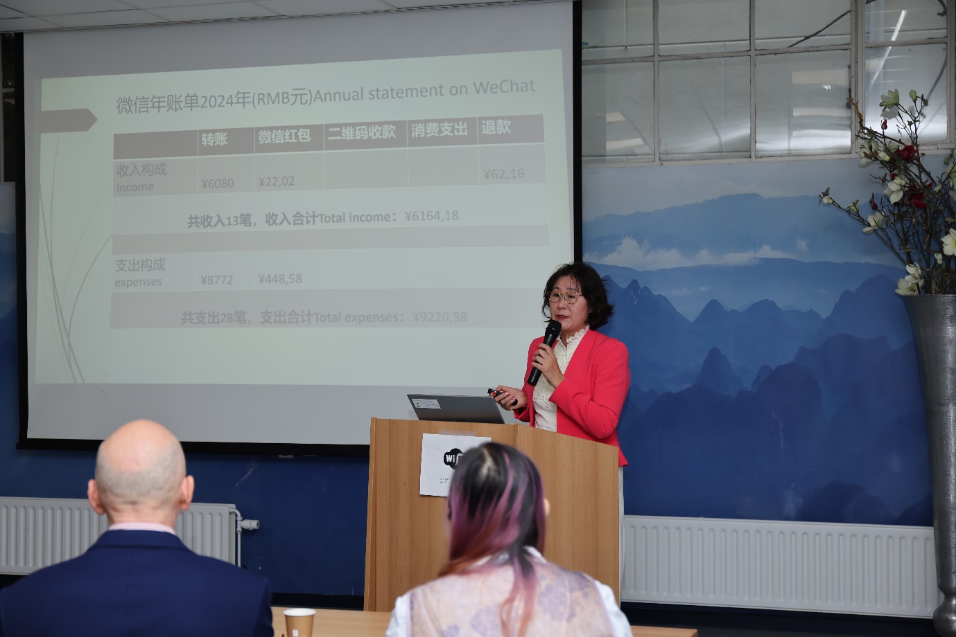 A person standing at a podium with a microphoneDescription automatically generated