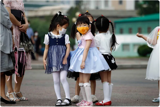 Kindergarten children wait for a bus in Pyongyang, North Korea, on June 19.